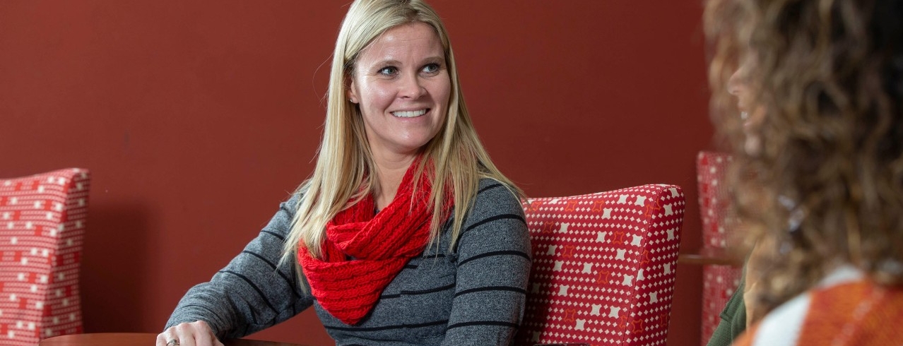A University of Cincinnati student converses in a study lounge
