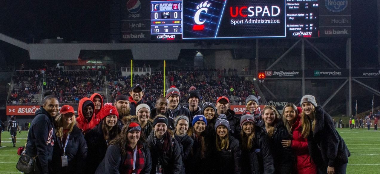 A group of University of Cincinnati students converse in an outdoor class