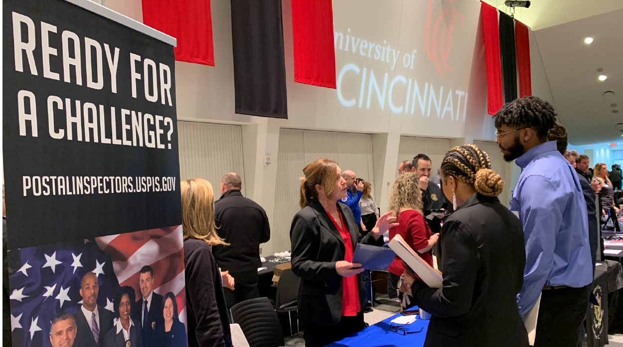 Students chatting with a recruiter during at a career fair booth
