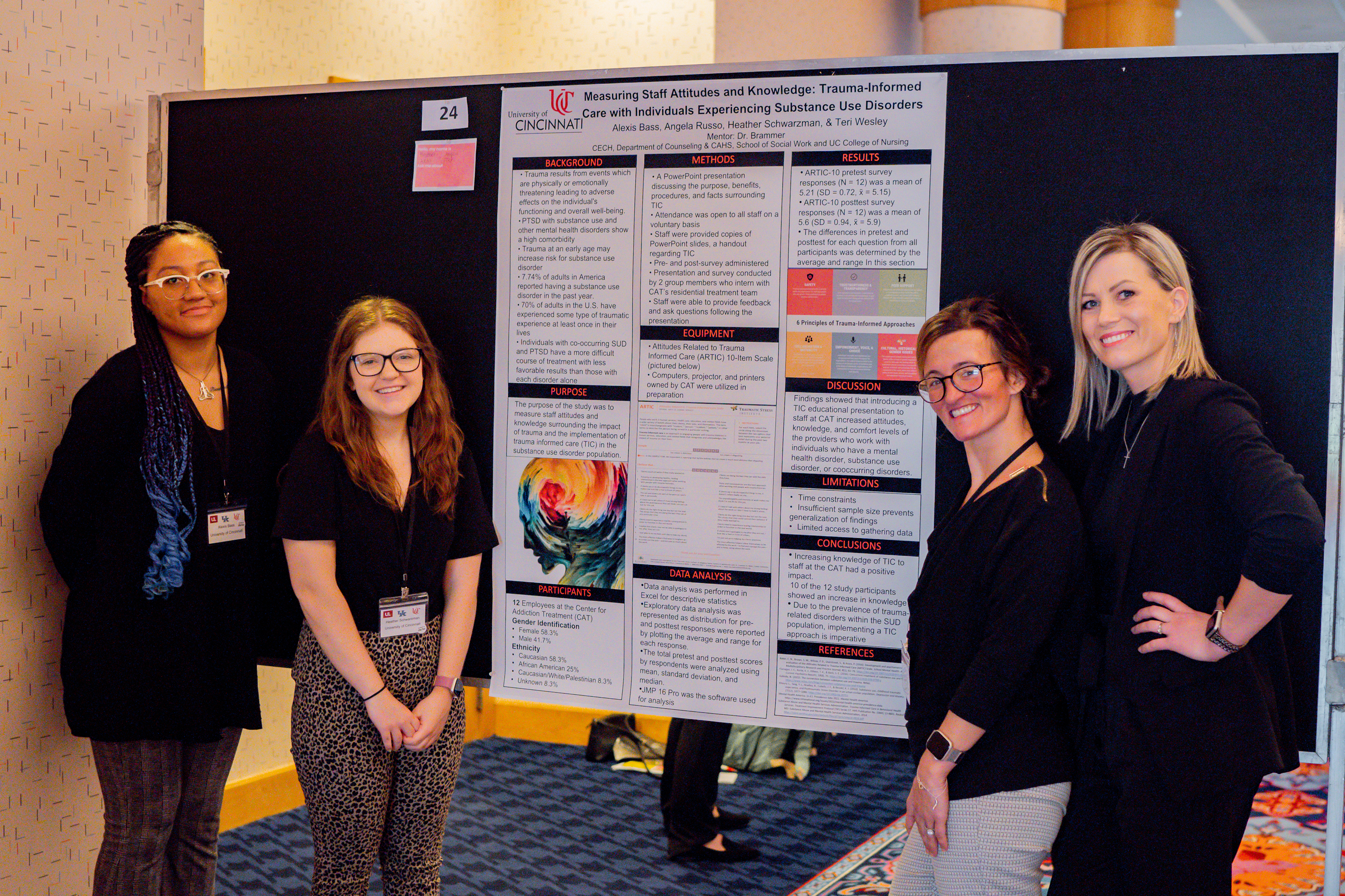 Attendees presenting research at conference