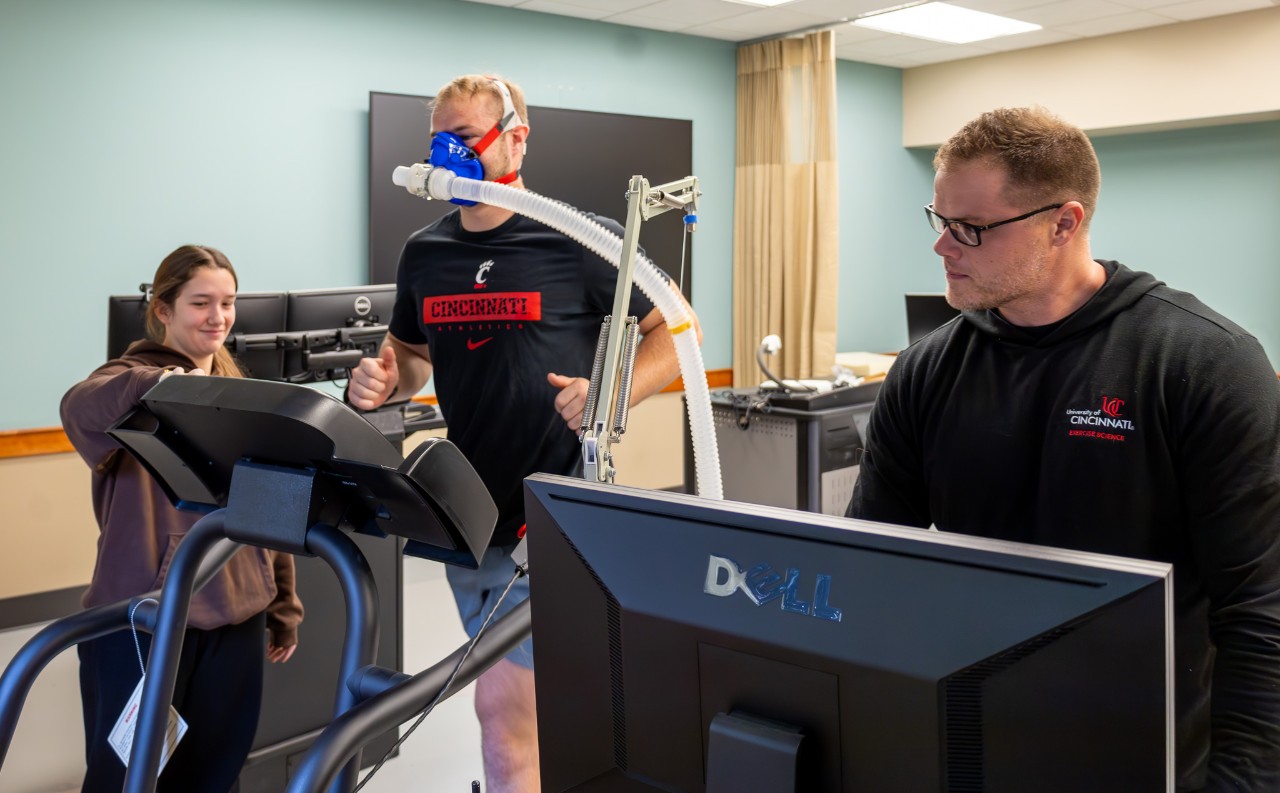 Student assisting a professor in the bearcats performance lab